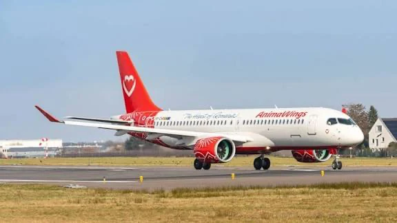 An AnimaWings Airbus A220 on the runway, in the red and white livery of the airline